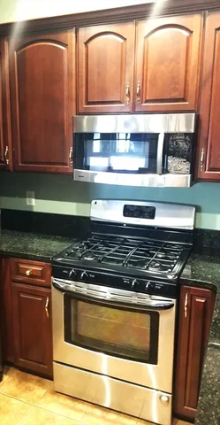 a stove top oven sitting inside of a kitchen