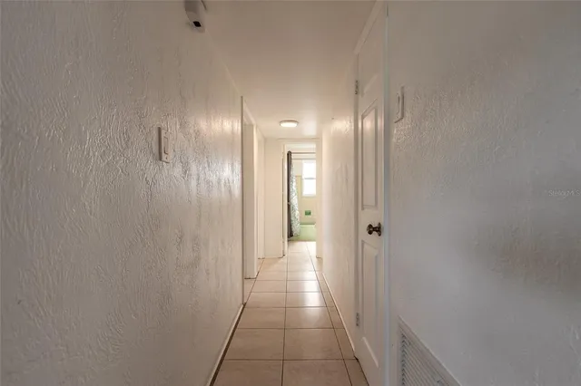 a view of a kitchen with kitchen island a sink stainless steel appliances and cabinets