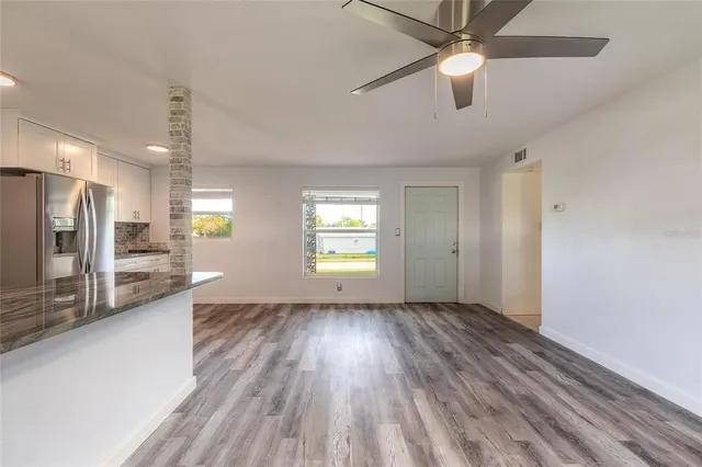 a kitchen with granite countertop a sink and steel appliances