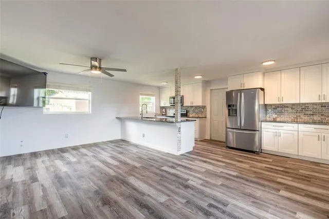 a kitchen with kitchen island granite countertop appliances cabinets and a counter space