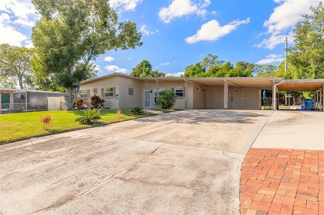 a swimming pool with yard in front of it