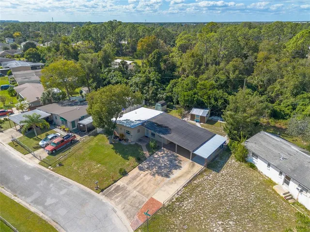 an aerial view of a house with a yard basket ball court and outdoor seating