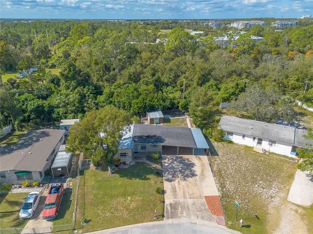 an aerial view of residential houses with outdoor space