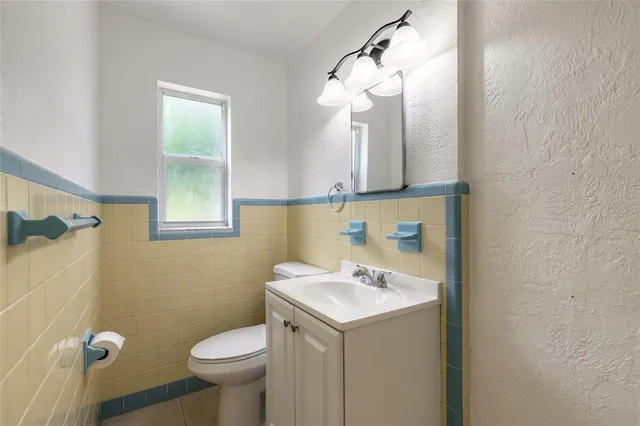a bathroom with a sink a toilet and mirror