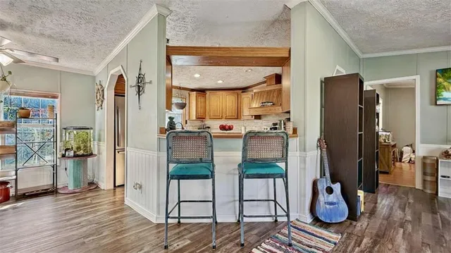 a kitchen with stainless steel appliances granite countertop a refrigerator and cabinets