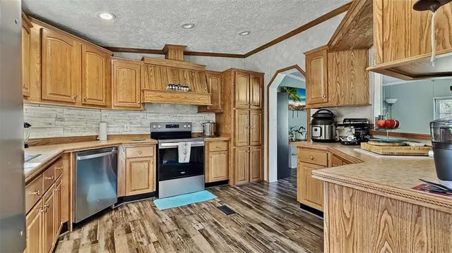 a kitchen with a sink cabinets and wooden floor