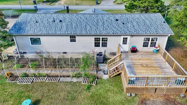 a front view of a house with a garden and plants
