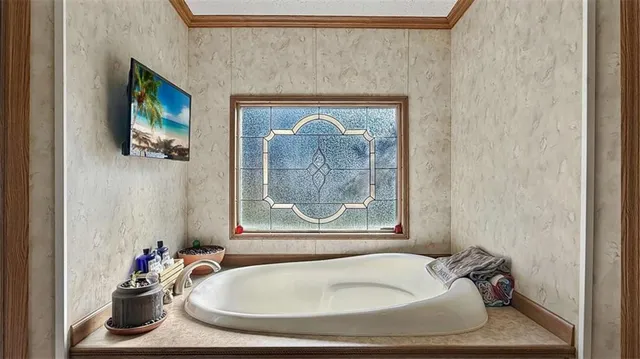 a bathroom with a tub and a sink