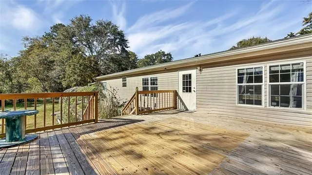 a view of a yard with plants and wooden fence