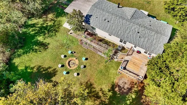 an aerial view of a house with a yard and swimming pool