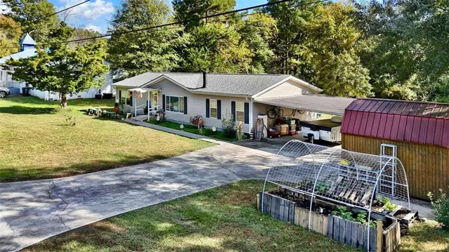 a view of a house with backyard and sitting area