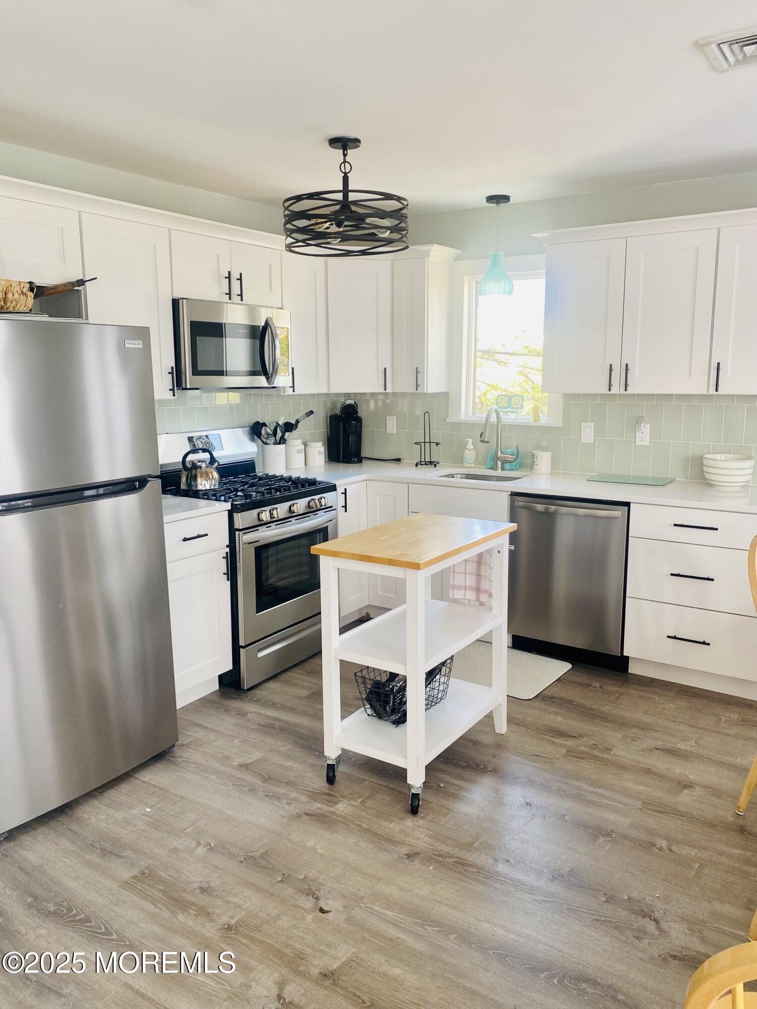 104 5th Avenue, Unit UP Seaside Heights, NJ 08751 - Photo 2 of 17 a kitchen with stainless steel appliances a stove a sink and a refrigerator