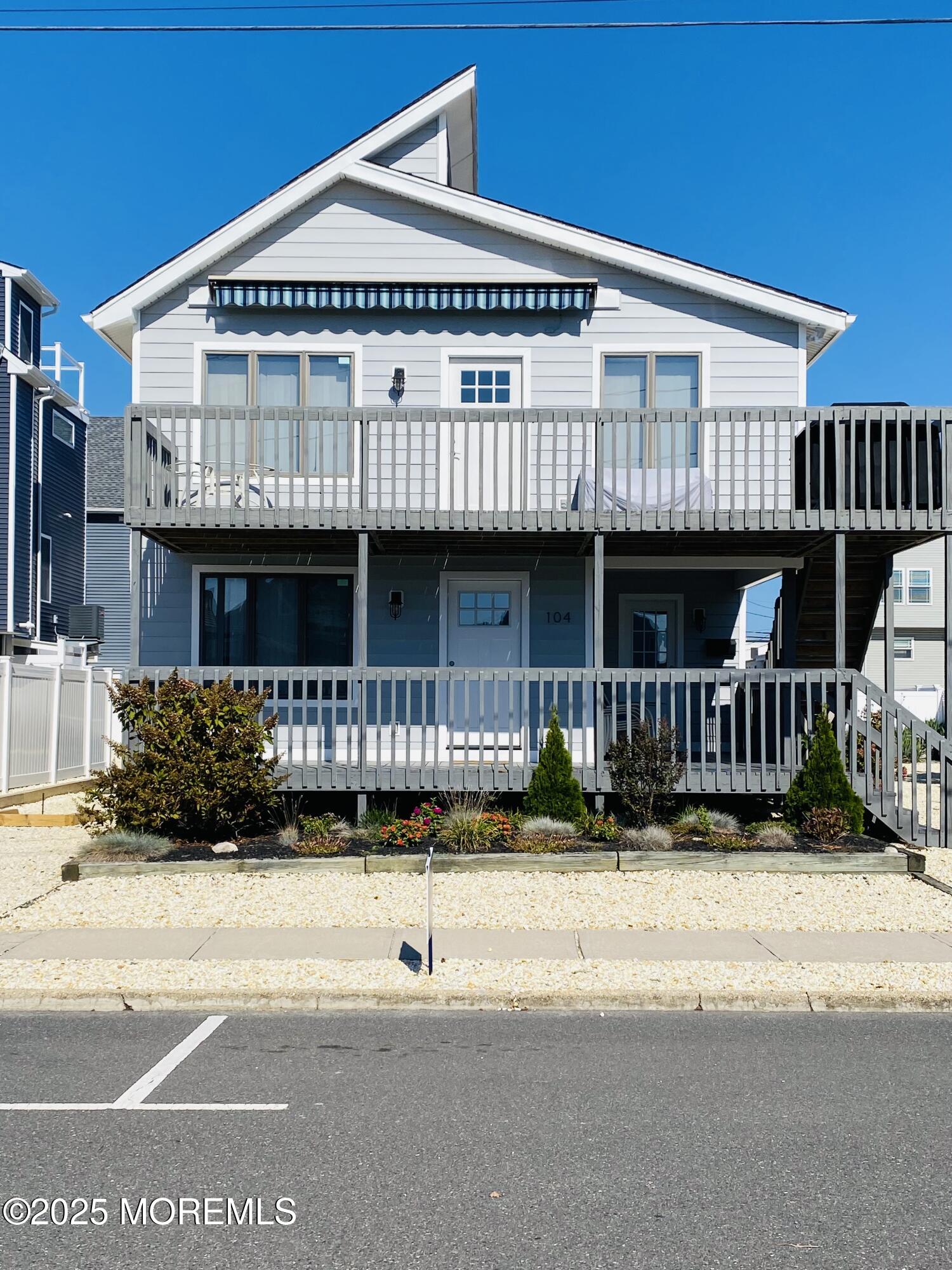 104 5th Avenue, Unit UP Seaside Heights, NJ 08751 - Photo 3 of 17 a front view of a house with a yard