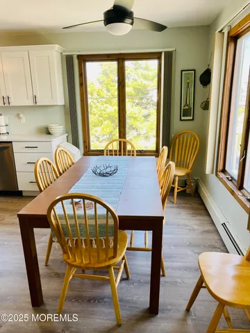 a view of a dining room with furniture window and wooden floor