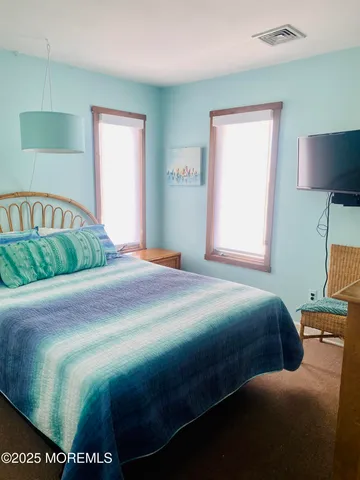 a bedroom with a bed and a lamp