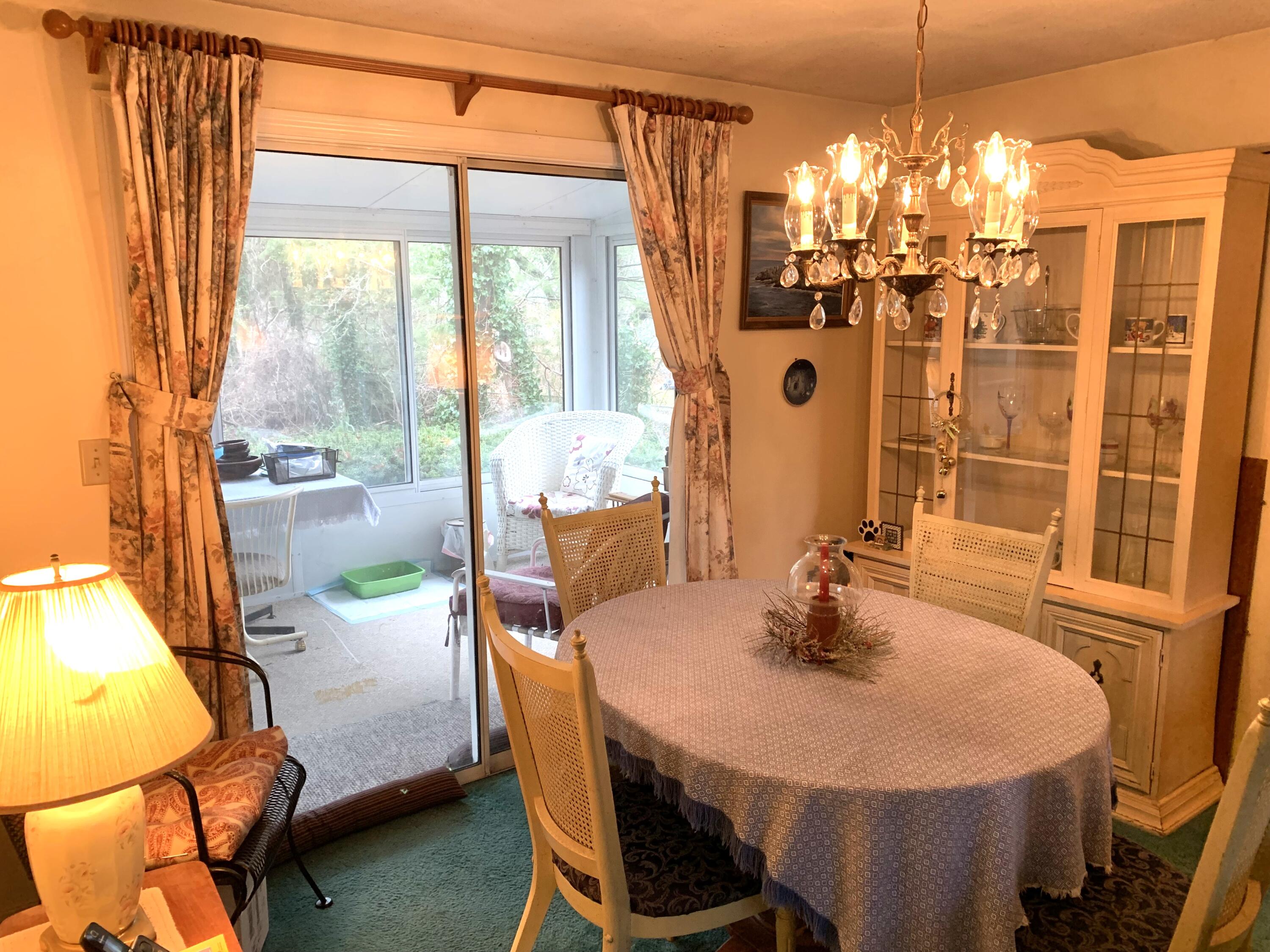 139 Telegraph Road Dennis Port, MA 02639 - Photo 5 of 16 a dining room with a table and chairs