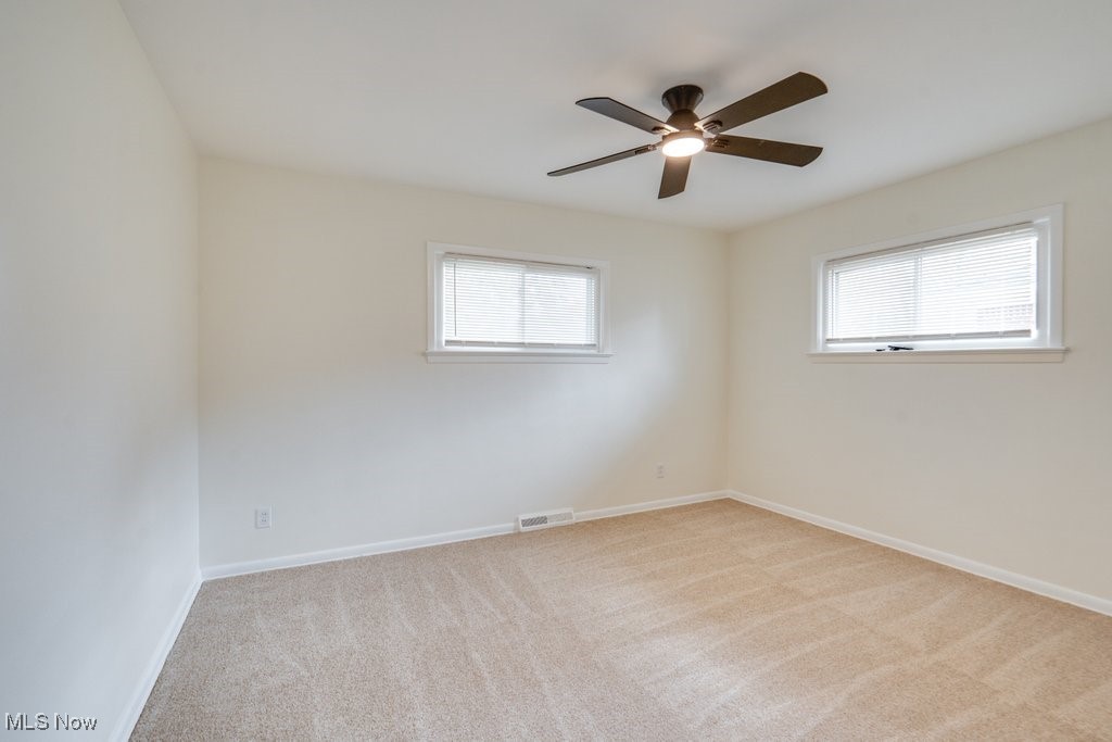 6961 Maplewood Road Parma Heights, OH 44130 - Photo 11 of 22 Carpeted spare room featuring a healthy amount of sunlight and ceiling fan