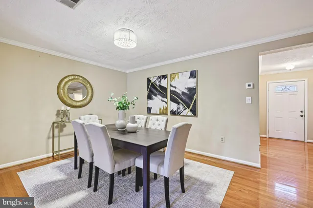 a dining room with furniture and wooden floor