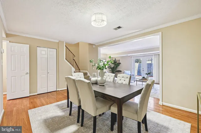 a dining room with furniture and wooden floor