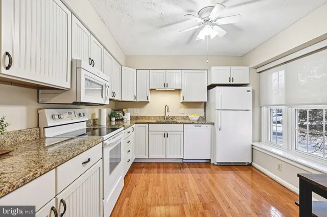 a kitchen with a refrigerator a stove a microwave and cabinets