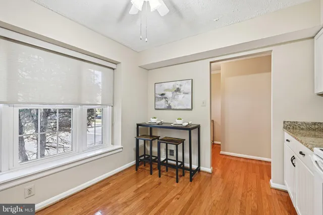 a dining room with wooden floor and a window