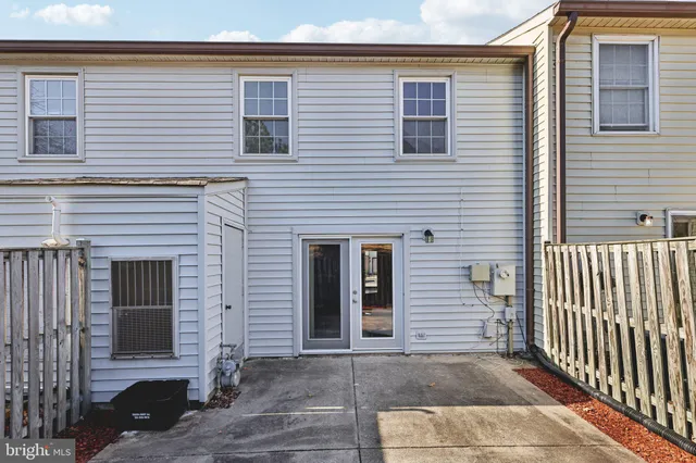 a view of a house with wooden fence