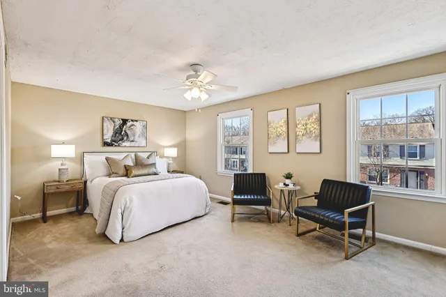 a bedroom with bed and a large window