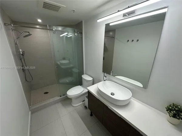 a view of an empty room with window and cabinet