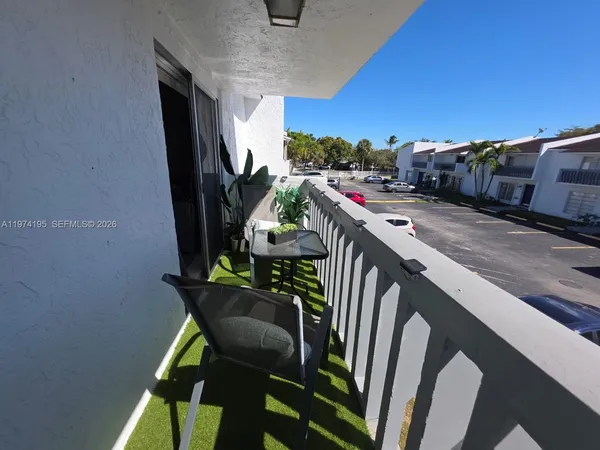a view of a swimming pool with a couple of chairs
