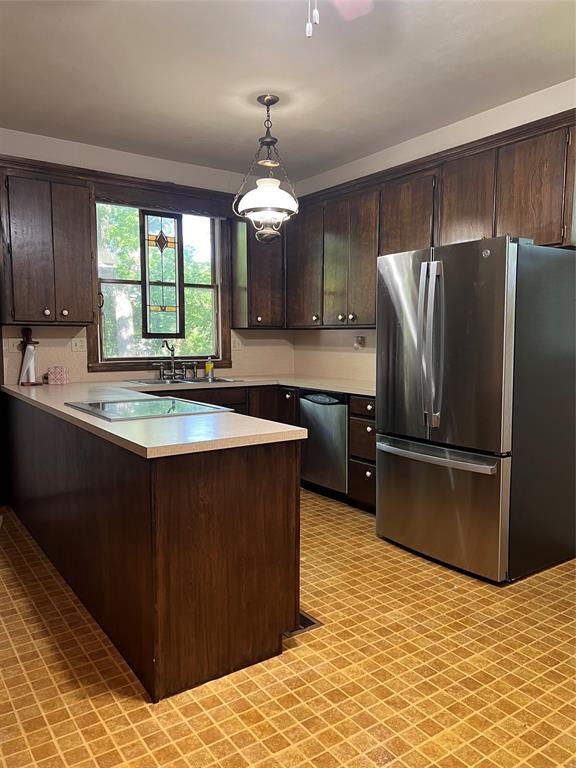 505 North Elm Street Comanche, TX 76442 - Photo 11 of 40 a kitchen with stainless steel appliances granite countertop a sink dishwasher a refrigerator and a cabinets with wooden floor