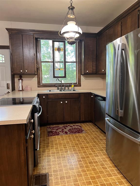 505 North Elm Street Comanche, TX 76442 - Photo 12 of 40 a kitchen with a sink a refrigerator and window