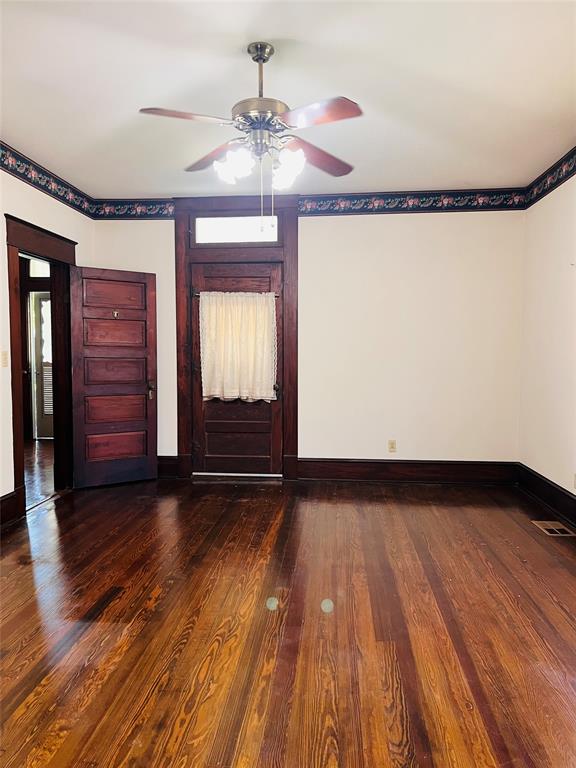 505 North Elm Street Comanche, TX 76442 - Photo 18 of 40 a view of an empty room with wooden floor and a window