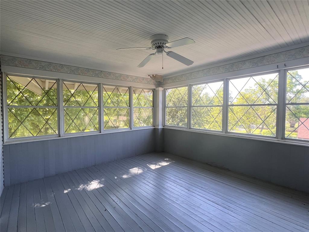 505 North Elm Street Comanche, TX 76442 - Photo 25 of 40 an empty room with wooden floor and windows