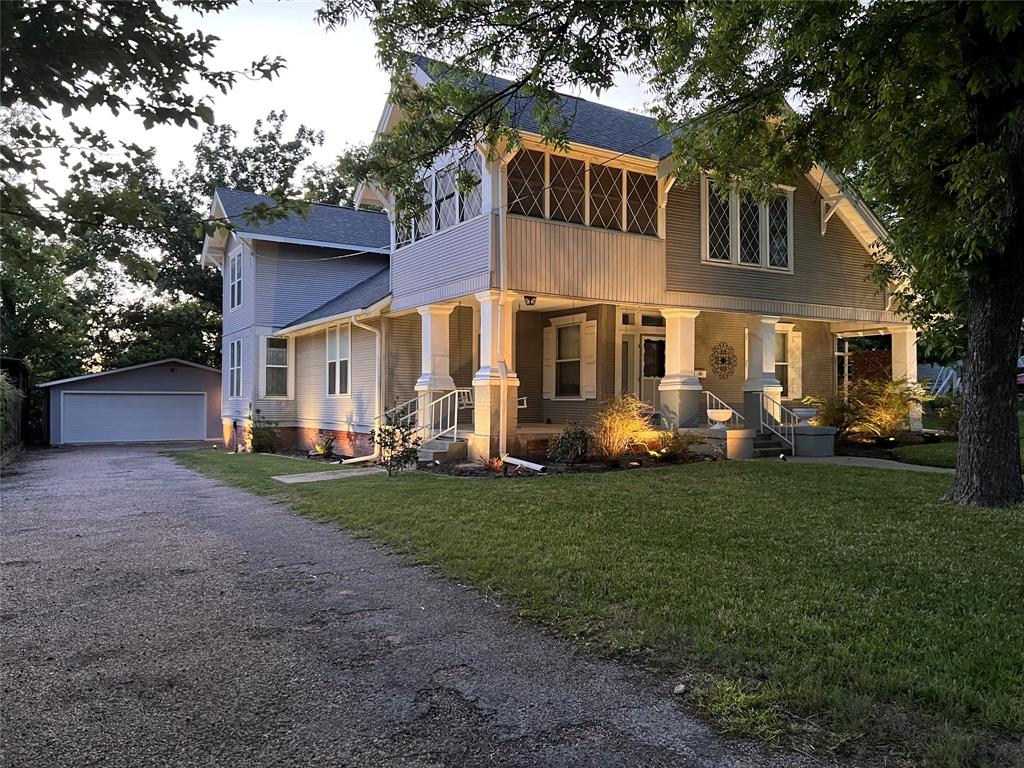 505 North Elm Street Comanche, TX 76442 - Photo 40 of 40 a front view of a house with a garden and trees