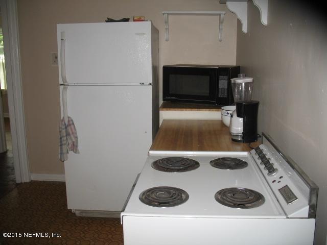 4834 Dundee Road Jacksonville, FL 32210 - Photo 12 of 28 a white refrigerator freezer sitting inside of a kitchen