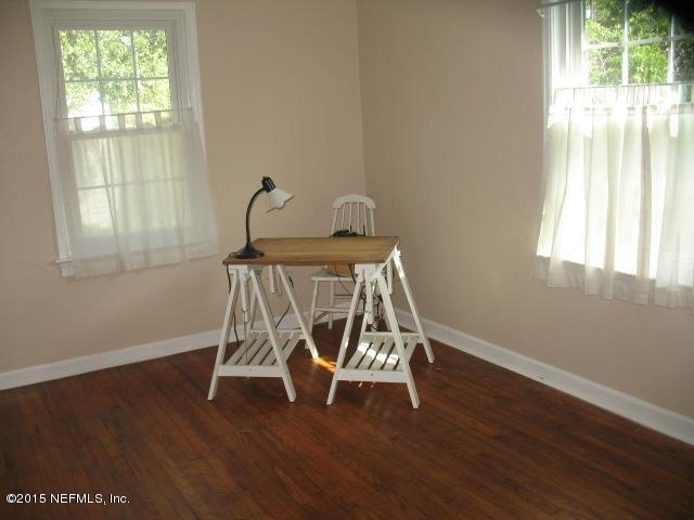 4834 Dundee Road Jacksonville, FL 32210 - Photo 13 of 28 a view of a room with wooden floor and windows