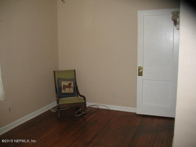 4834 Dundee Road Jacksonville, FL 32210 - Photo 15 of 28 a room with a bench and wooden floor