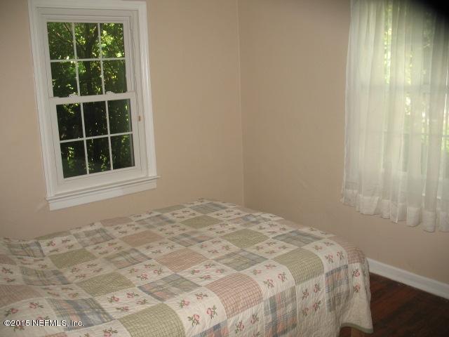 4834 Dundee Road Jacksonville, FL 32210 - Photo 16 of 28 a view of a bedroom with a bed and a window