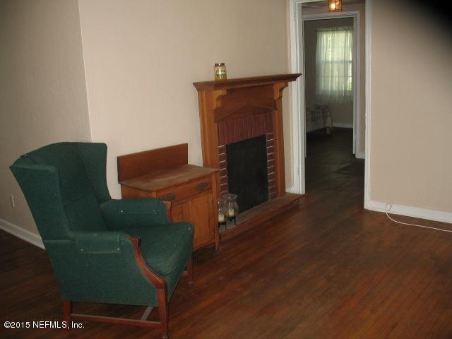 4834 Dundee Road Jacksonville, FL 32210 - Photo 6 of 28 a living room with furniture and a fireplace