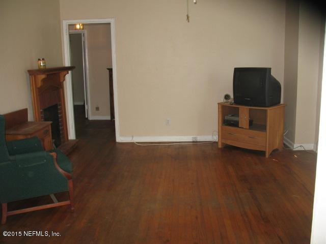 4834 Dundee Road Jacksonville, FL 32210 - Photo 7 of 28 a view of a livingroom with furniture and a flat screen tv