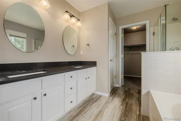 a bathroom with a double vanity sink and a mirror