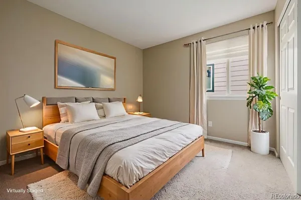 a bedroom with bed and a potted plant