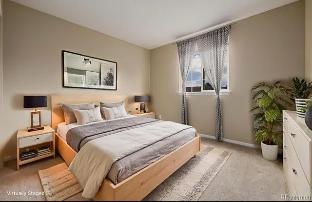 a bedroom with a bed and a potted plant