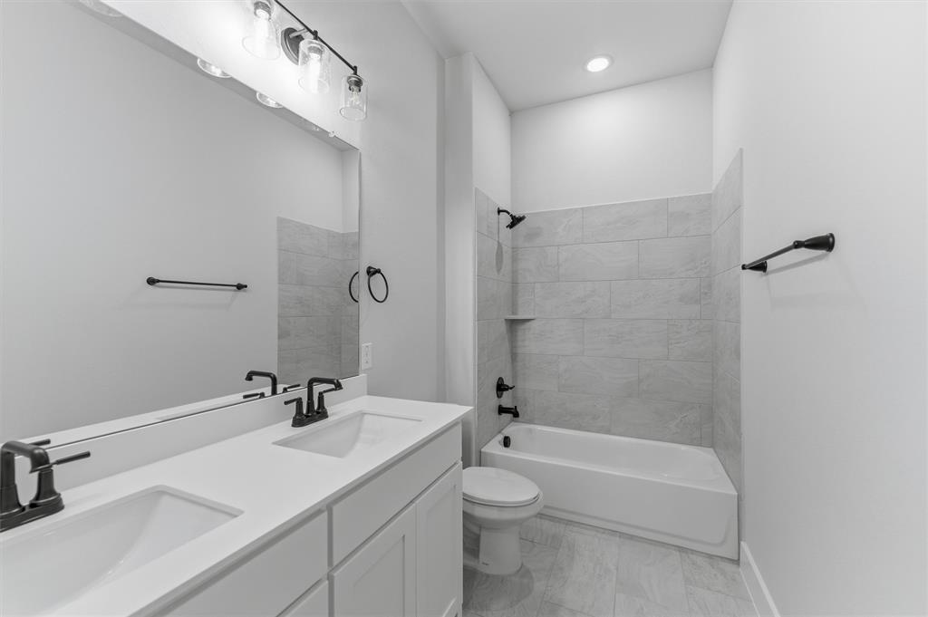 814 Vly Rdg Road Van Alstyne, TX 75495 - Photo 16 of 24 a bathroom with a sink a toilet and shower