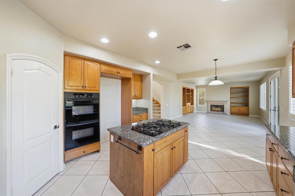 2612 Coyote Ridge Terrace Chula Vista, CA 91915 - Photo 25 of 57 a kitchen with stainless steel appliances granite countertop a stove and a refrigerator