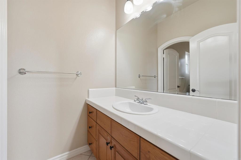 2612 Coyote Ridge Terrace Chula Vista, CA 91915 - Photo 43 of 57 a bathroom with a sink and a mirror