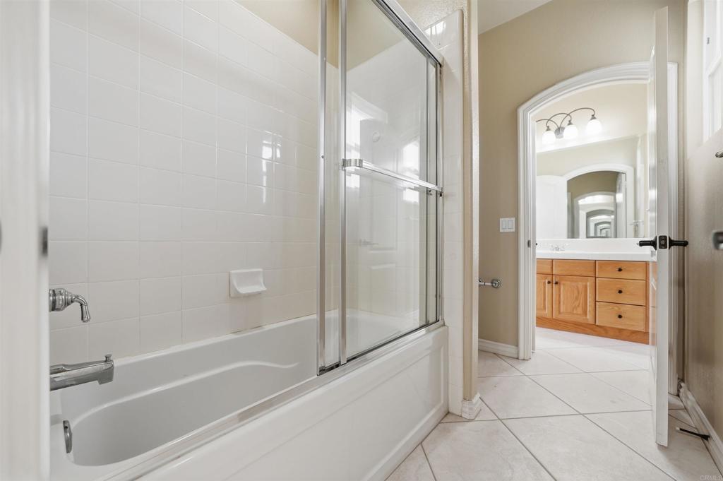 2612 Coyote Ridge Terrace Chula Vista, CA 91915 - Photo 44 of 57 a bathroom with a granite countertop sink mirror bathtub and shower