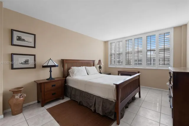 a bedroom with a bed and a night stand