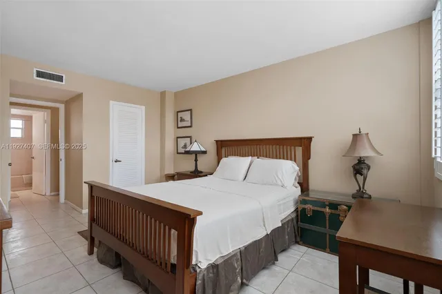 a bedroom with a bed and a table