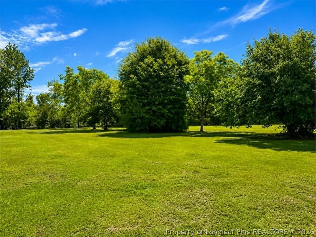 4435 Tartt's Mill Road Wilson, NC 27893 - Photo 20 of 23 a view of a swimming pool with an outdoor space and seating area